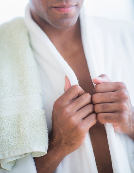 Young man in white bathrobe