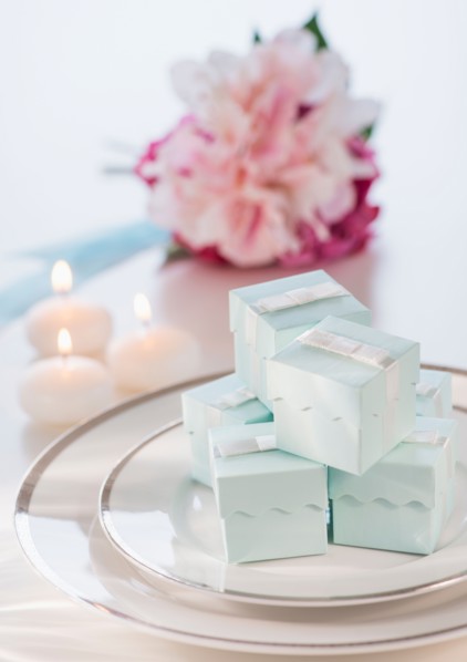 Pastel composition with gifts packages, candles and flowers