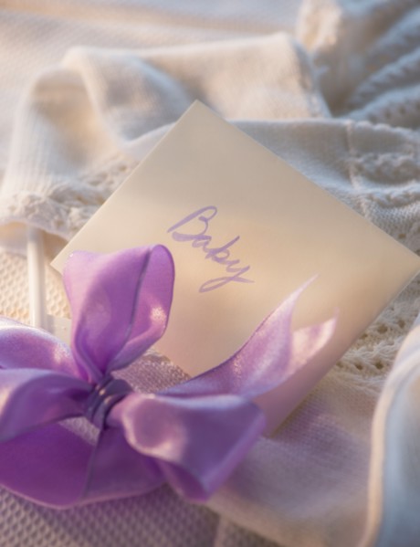 Close-up of envelope and purple bow