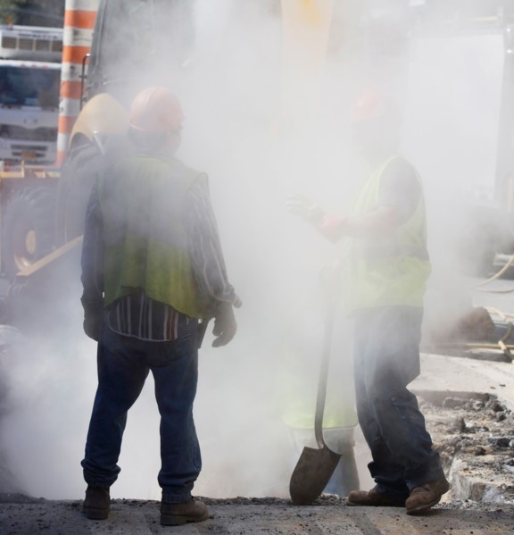 Construction workers digging hole