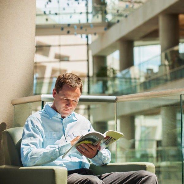 Portrait of man reading in armchair