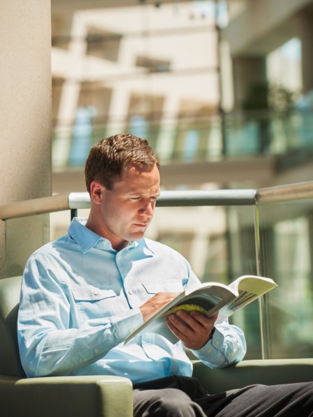 Portrait of man reading in armchair
