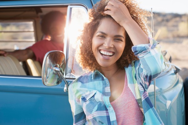 Woman in foreground with friend during their road trip
