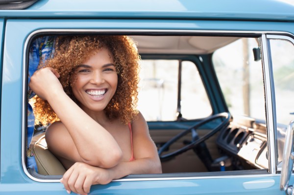 Portrait of smiling woman sitting in van