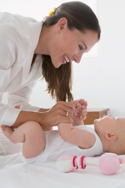 Smiling mother and baby daughter (6-11 months)