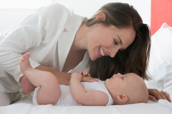Smiling mother and baby daughter (6-11 months)