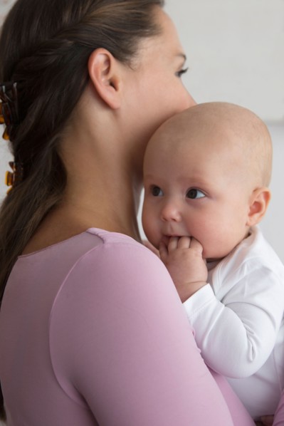 Mother holding baby daughter (6-11 months)