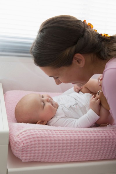 Mother playing with baby daughter (6-11 months)