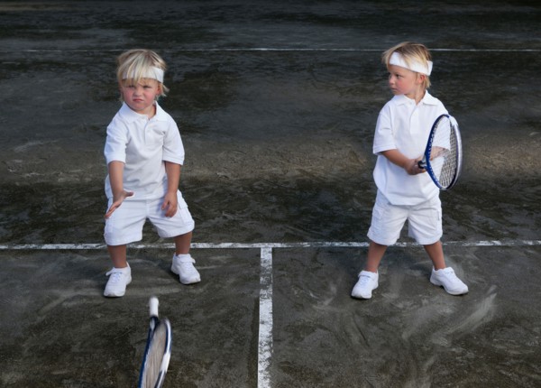 Two boys (2-3) playing tennis