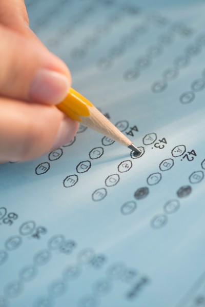 Close-up of hand filling out test.