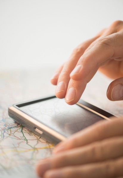 Close-up of hand using gps system.