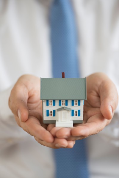 Man holding model house.