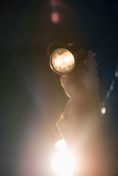 Hand holding flashlight.