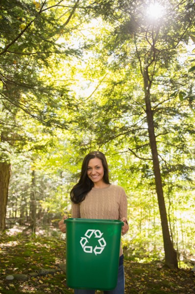 Woman holding recycling bin. Photo: Jamie Grill