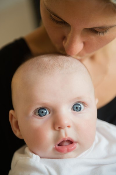 Mother kissing baby boy (2-5 months). Photo: Jamie Grill