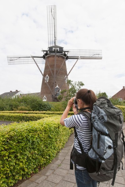 Woman photographing windmill. Photo : Jan Scherders