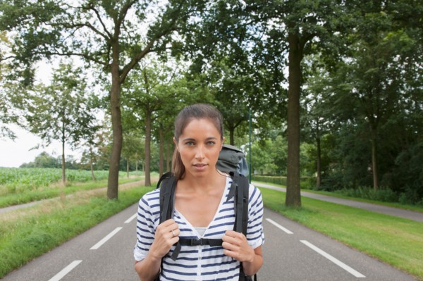 Portrait of young woman with backpack. Photo : Jan Scherders