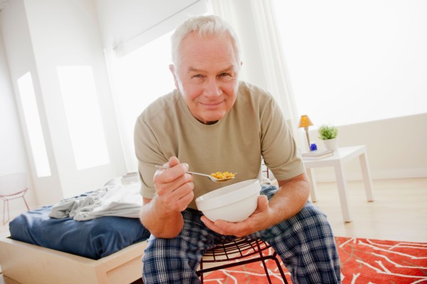 Senior man eating cereal from bowl. Photo: Rob Lewine