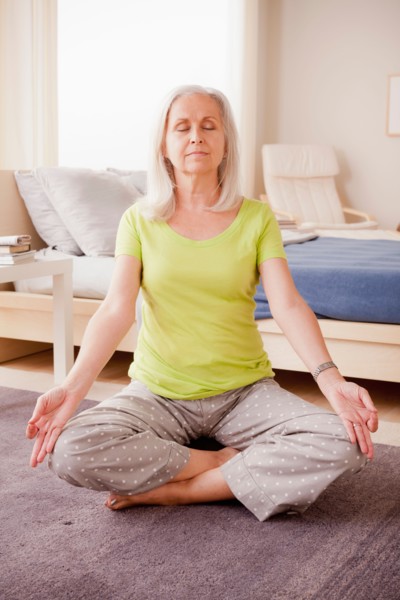 Senior woman practicing yoga. Photo: Rob Lewine