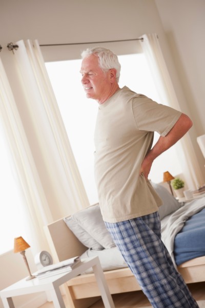 Senior man having backpain. Photo : Rob Lewine