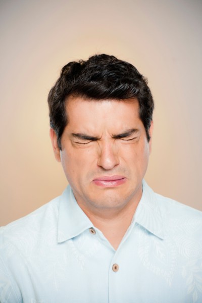 Portrait of man frowning with closed eyes. Photo: Rob Lewine