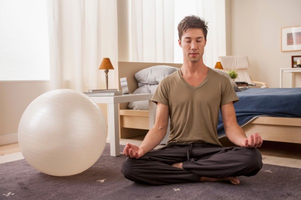 Portrait of man doing yoga. Photo : Rob Lewine