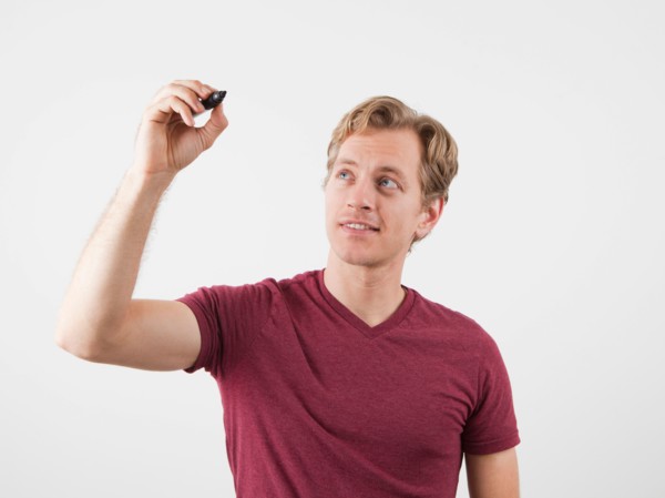 Portrait of man holding marker, ready to write. Photo: Jessica Peterson