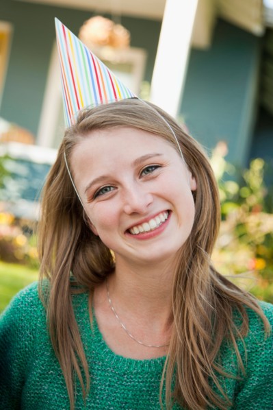 Portrait of young woman in party hat. Photo: Jessica Peterson