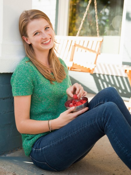 Portrait of young woman eating raspberries. Photo : Jessica Peterson