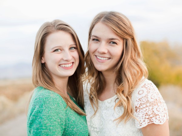 Portrait of two young women cheek to cheek. Photo : Jessica Peterson