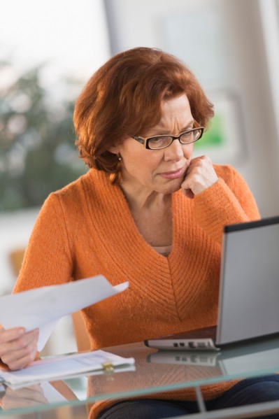 Senior woman working on laptop at home.