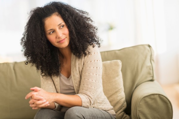 Portrait of mid adult woman sitting on sofa.