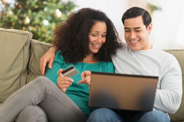 Couple using laptop for online shopping.