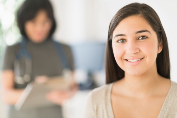 Teenage girl (16-17) in doctor's office.