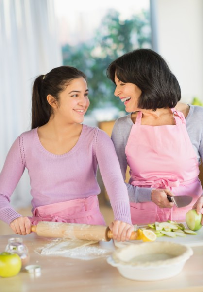 Grandmother and granddaughter (16-17) baking together.