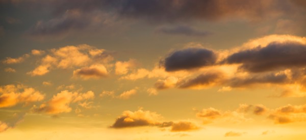 Puffy clouds at sunset.