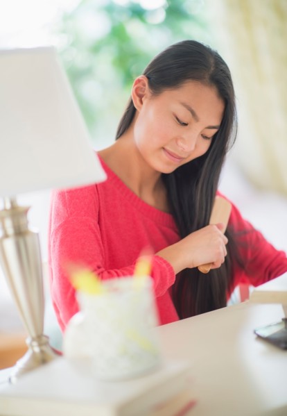 View of teenage girl ( 16-17 years) brushing hair