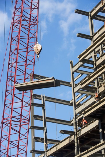 Crane lifting parts of metal frame