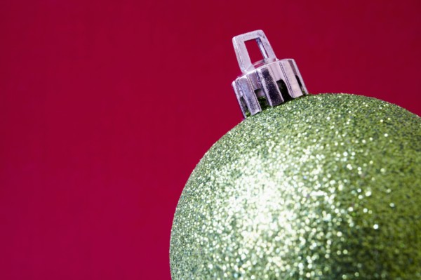 Close up of shiny Christmas decoration on red background