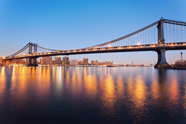 Cityscape with bridge lights reflected in water