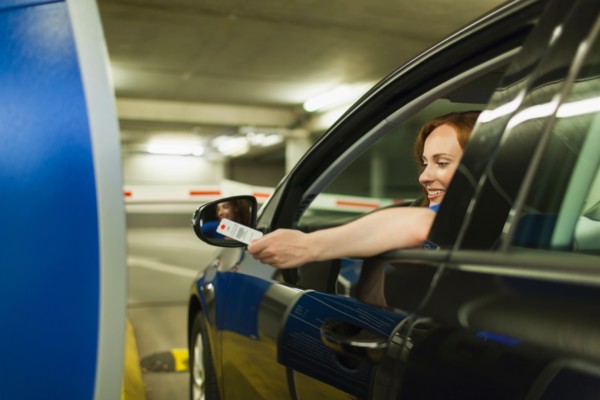 Young woman parking car