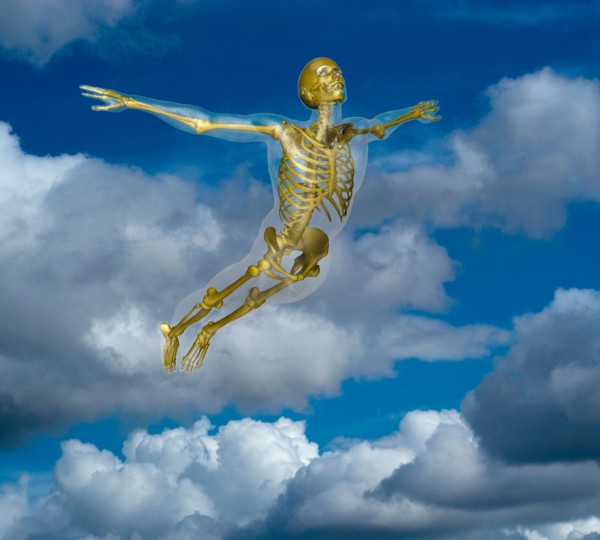Human skeleton flying amidst clouds