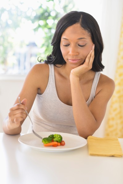 Woman eating vegetables.