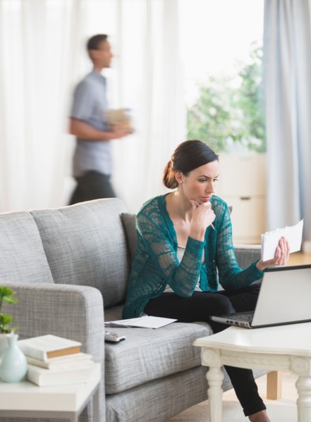 Woman using laptop to pay bills.