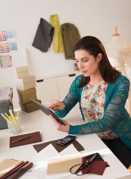 Fashion designer using digital tablet.