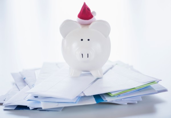 Still life with Santa piggy bank and bills
