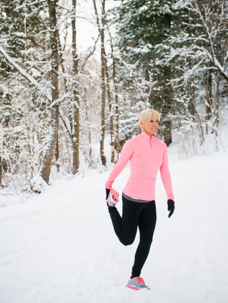 Woman exercising in winter forest