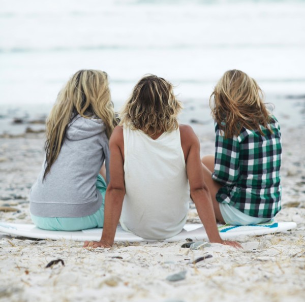 Rear view of people sitting on beach