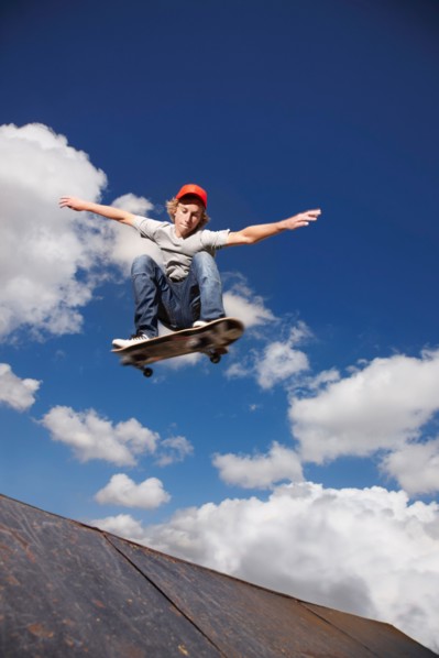 Young man on skateboard jumping