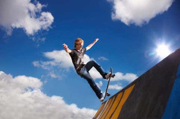 Young man on skateboard jumping